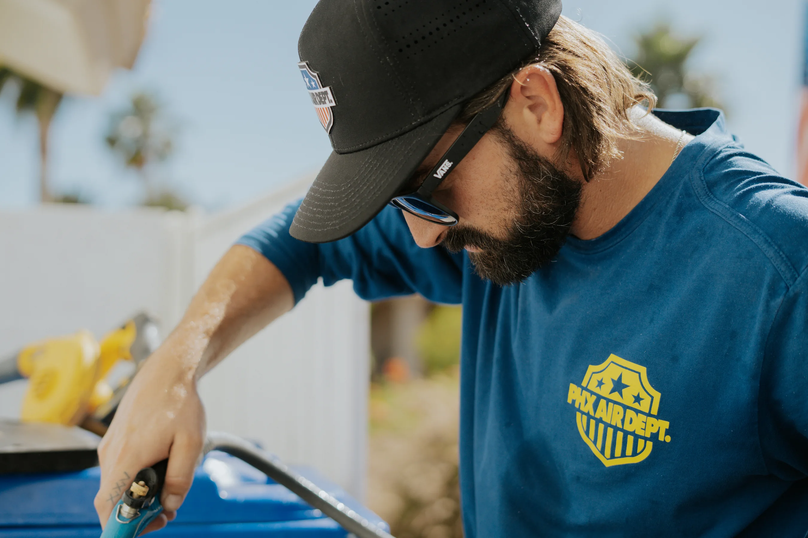 Phoenix Air Department technician servicing an AC unit in the field