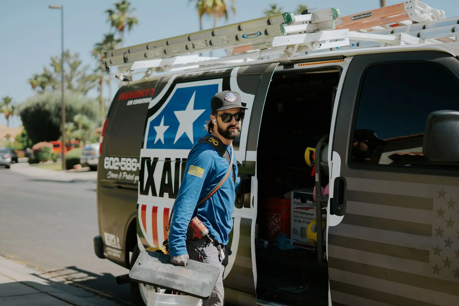 Phoenix Air Department technician loading equipment from the service van